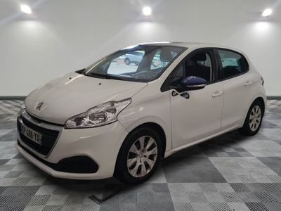 the small white car is parked in the garage on a checkered floor