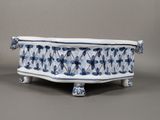 a blue and white planter with dragonflies on it