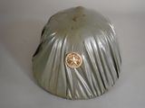 a silver hat with a gold button on it