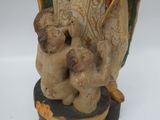 a figurine of a woman holding a child on her lap