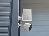 a security camera attached to the side of a building