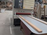 a picture of a table in a factory with a machine in the background