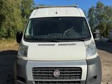 the front view of a white van parked in a parking lot