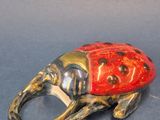 an elephant shaped ring with a ladybug on it ' s back