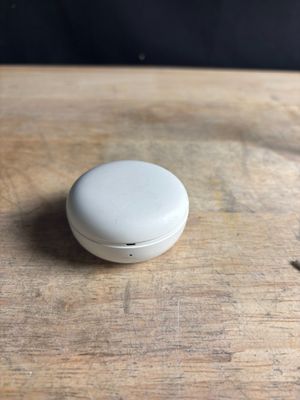 a small white object sitting on a wooden table
