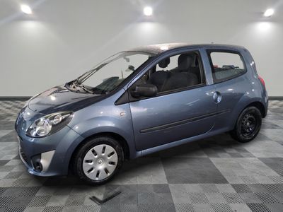 a picture of a small blue car parked on a checkered floor