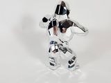 a silver figurine of a person holding a camera