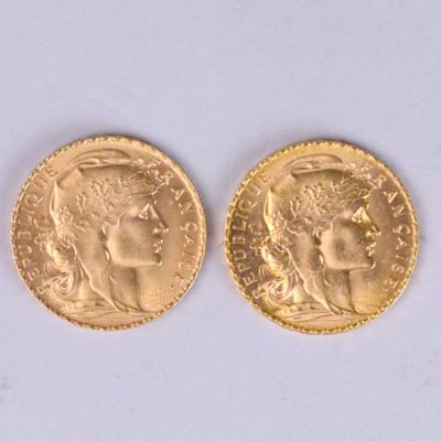 two pieces of gold coins with a woman ' s face on them