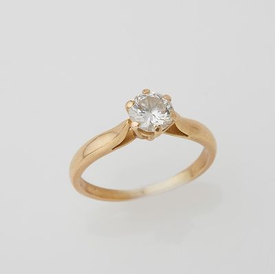 a gold ring with a white diamond on top of it