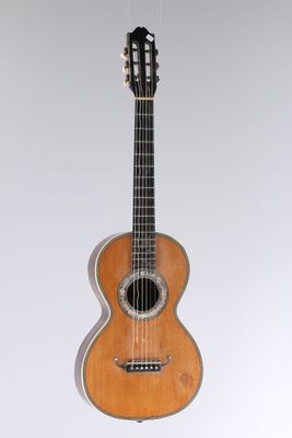 an image of a guitar hanging from a string on a wall