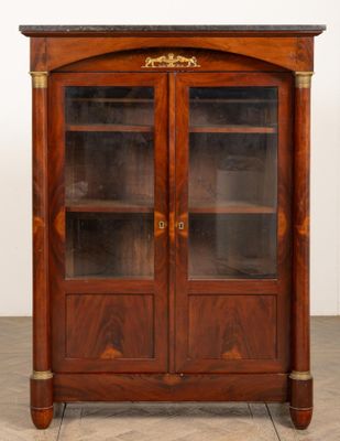 an image of a wooden cabinet with glass doors in a room