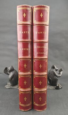 two red books sitting on top of each other next to a mouse