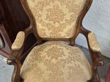 a chair that is sitting in front of a dresser