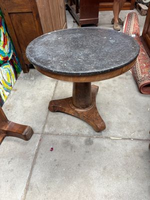 une table posée sur le trottoir devant une chaise