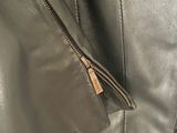 a close up of a black leather jacket with a zipper on it