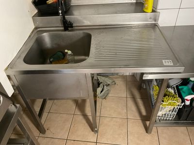 a stainless steel sink in a kitchen next to a counter