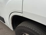 a white truck that is parked on the side of the road