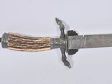 a knife with a wooden handle on a white surface