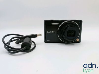 an image of a black camera with a cord attached to it