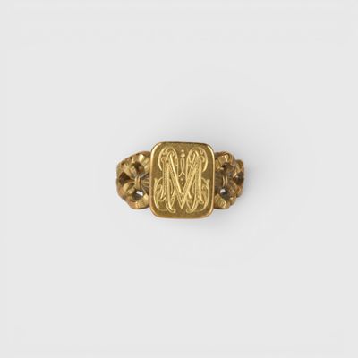 a gold ring with an image of a man and a woman on it