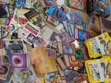 a pile of comic books on the floor next to a laptop