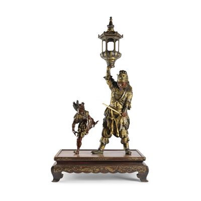 une figurine antique en bronze représentant un homme et un chien tenant une lanterne