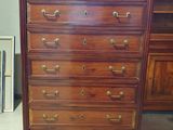 a wooden dresser with a marble top on it