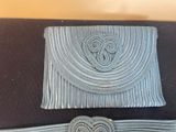 two pieces of blue knit with a heart on the front and a heart on the back