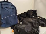 a blue backpack sitting on a white shelf next to a pair of black pants