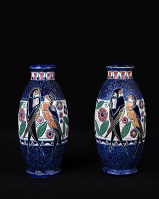 une paire de vases bleus ornés d'oiseaux et de fleurs sur fond noir