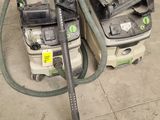 two vacuums that are sitting on the floor next to each other