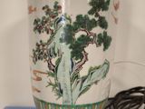 a vase with a tree on it sitting on a table