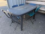 a table and chairs that are outside in the sun