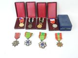 several medals and medals are in a wooden case on a white surface