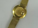 an image of a close up of a gold watch on a white surface