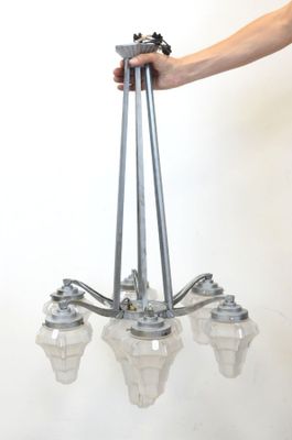 a person that is holding a chandelier in their hand