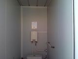 a small bathroom with a toilet and a water heater in it