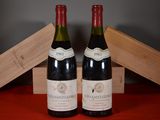 two bottles of wine sitting next to each other on a table