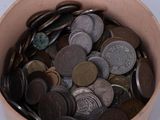 a bucket full of coins sitting on a table