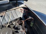 an old car engine with a lot of wires in it