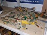 a table with a bunch of toy airplanes on it