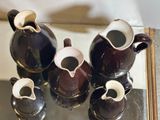a group of vases that are sitting on a table