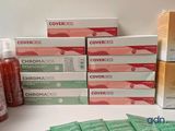 several boxes of covers on a table next to a bottle of liquid