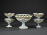 four white and gold footed bowls with gold rims