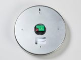 a button on the wall with a green button on it