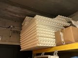 many boxes and boxes on a shelf in a room