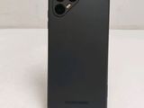 a close up of the back of a black phone case on a white surface