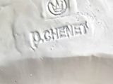 a close up of a white porcelain object on a table