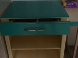 a green table with a drawer on it in a bathroom