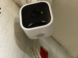 a small camera attached to the wall next to a cup of coffee